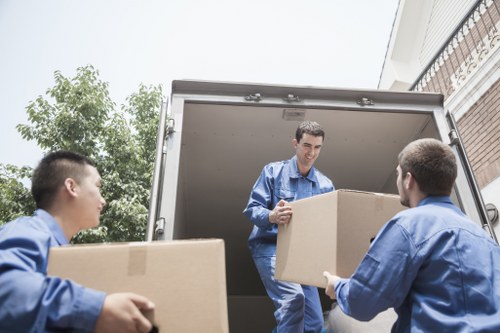 Local moving truck loading household items in Becontreeheath