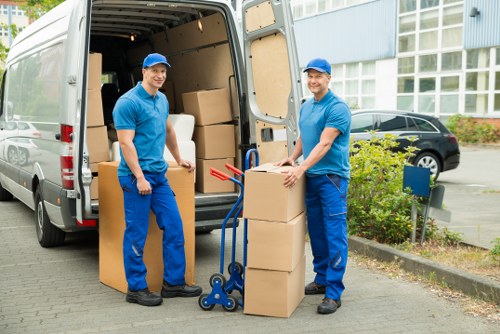 Movers carrying belongings through a residential property