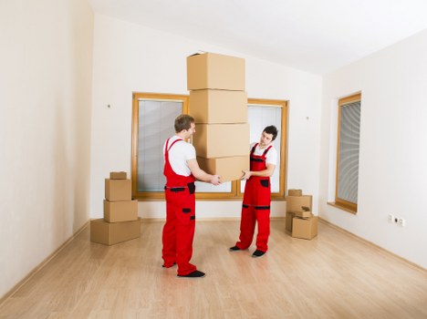 Office movers handling desks and equipment during a local move