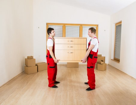 Packed office equipment and furniture ready for transport during a local business move